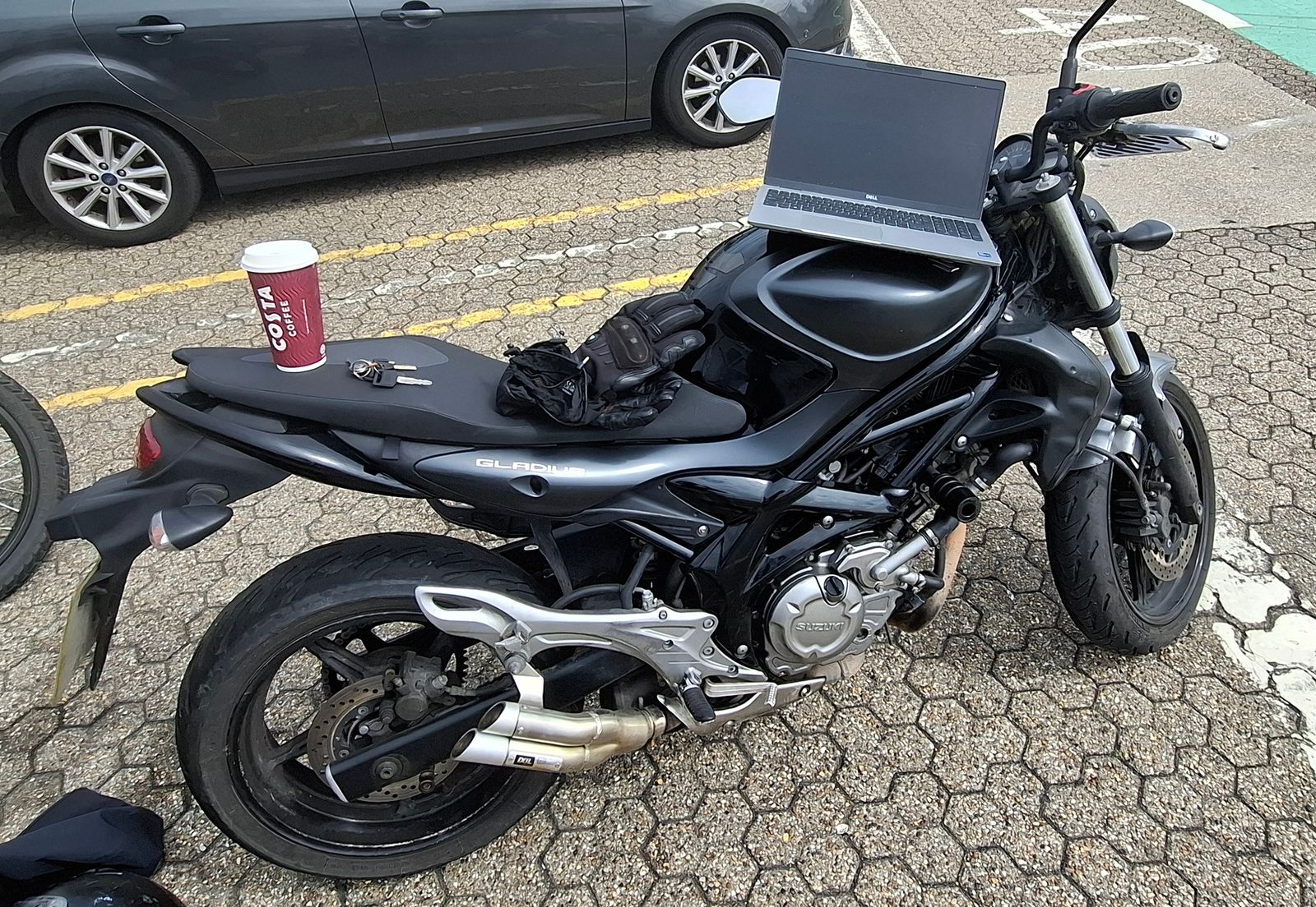 My laptop perched on my motorbike, along with a coffee cup, my
keys, and my gloves.